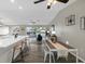 Open dining area with an adjacent kitchen and views of a covered porch with outdoor seating at 824 35Th Avenue W Dr, Palmetto, FL 34221