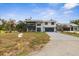 Two-story home featuring a charming balcony, complemented by a well-manicured lawn and driveway at 824 35Th Avenue W Dr, Palmetto, FL 34221