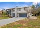 Two-story home featuring a balcony and a well-maintained lawn, enhancing its curb appeal at 824 35Th Avenue W Dr, Palmetto, FL 34221