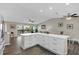 Spacious kitchen with white cabinetry, stainless steel appliances, a center island and an adjacent dining and living area at 824 35Th Avenue W Dr, Palmetto, FL 34221