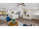 Open-concept living room and kitchen featuring modern white cabinets and stainless steel appliances at 824 35Th Avenue W Dr, Palmetto, FL 34221
