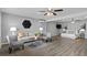 Spacious open-concept living room and bedroom with ceiling fans, vinyl floors, and modern decor at 824 35Th Avenue W Dr, Palmetto, FL 34221