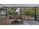 Covered porch features seating and views of the yard through the screened in railing at 824 35Th Avenue W Dr, Palmetto, FL 34221