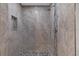 Tiled walk-in shower featuring neutral tile, pebble floor, and built-in shower caddy at 824 35Th Avenue W Dr, Palmetto, FL 34221