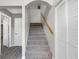 Carpeted staircase with a light wood handrail, leading to the upper level of the home at 824 35Th Avenue W Dr, Palmetto, FL 34221