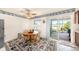 Bright dining area with natural light, ceiling fan and sliding glass door to outdoor patio at 8305 Palencia Dr, Port Richey, FL 34668