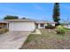 Charming single story home with attached garage and well-kept landscaping in a quiet neighborhood at 8305 Palencia Dr, Port Richey, FL 34668
