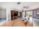 Open-concept living area with laminate flooring and sliding door access to the backyard at 8305 Palencia Dr, Port Richey, FL 34668