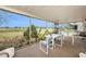 Enclosed patio with table and chairs overlooking green space and pool at 8305 Palencia Dr, Port Richey, FL 34668