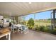 Enclosed patio with table and chairs overlooking green space at 8305 Palencia Dr, Port Richey, FL 34668