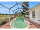 Inviting kidney-shaped pool enclosed by a screen offers a relaxing space with golf course views at 8305 Palencia Dr, Port Richey, FL 34668