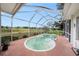 Relaxing kidney shaped pool inside of screened enclosure offers beautiful views of the property at 8305 Palencia Dr, Port Richey, FL 34668