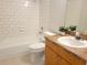 Bathroom featuring a tub with tiled walls, a toilet, and a wooden vanity at 906 Balmoral Pl, Valrico, FL 33594