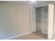 Bright bedroom featuring a closet with bi-fold doors and installed storage shelving at 906 Balmoral Pl, Valrico, FL 33594