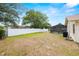 Spacious backyard with a pristine white fence and a screened-in pool area, offering privacy and relaxation at 9114 Dorsey St, Spring Hill, FL 34608