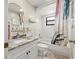 Charming bathroom with marble countertops, a shower/tub combo, and a modern vanity at 9114 Dorsey St, Spring Hill, FL 34608