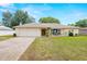 Charming single-story home featuring a brick driveway, two-car garage and a cozy front porch at 9114 Dorsey St, Spring Hill, FL 34608