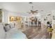 Open living room with hardwood floors, a breakfast bar, and easy access to the kitchen and dining area at 9114 Dorsey St, Spring Hill, FL 34608