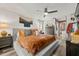 Spacious main bedroom with a king bed, wooden floors, and access to the en-suite bathroom at 9114 Dorsey St, Spring Hill, FL 34608