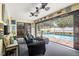 Inviting screened-in patio with comfortable seating overlooks a sparkling in-ground swimming pool, perfect for relaxing at 9114 Dorsey St, Spring Hill, FL 34608
