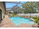 Refreshing in-ground swimming pool surrounded by a screened enclosure and brick pavers, great for outdoor fun at 9114 Dorsey St, Spring Hill, FL 34608