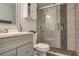 Updated bathroom featuring a glass-enclosed shower and modern vanity at 9481 Highland Oak Dr # 710, Tampa, FL 33647