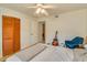 Bright bedroom with ceiling fan, louvred closet, and comfortable chair at 9481 Highland Oak Dr # 710, Tampa, FL 33647