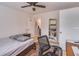 Well-lit bedroom featuring neutral walls, ceiling fan, and practical furnishings; bookshelf and desk at 9481 Highland Oak Dr # 710, Tampa, FL 33647