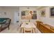 Open dining room featuring a light wood table and chairs and a modern sideboard at 9481 Highland Oak Dr # 710, Tampa, FL 33647