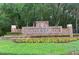 Community entrance sign for Hunter's Green amidst lush landscaping and mature trees at 9481 Highland Oak Dr # 710, Tampa, FL 33647