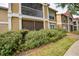 Exterior of building with lots of greenery and an enclosed porch at 9481 Highland Oak Dr # 710, Tampa, FL 33647