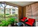 Screened patio with seating overlooking lush landscaping at 9481 Highland Oak Dr # 710, Tampa, FL 33647