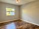 Bedroom with hardwood flooring, a ceiling fan, and a window with backyard views at 9893 86Th N Way, Seminole, FL 33777