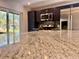 Close up of granite countertops in a kitchen with stainless steel appliances in background at 9893 86Th N Way, Seminole, FL 33777