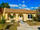 Charming single-story home with a well-maintained front yard and beautiful blue skies at 9893 86Th N Way, Seminole, FL 33777