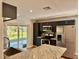 Kitchen with stainless steel appliances, sleek dark cabinets, and granite countertops at 9893 86Th N Way, Seminole, FL 33777