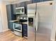 Kitchen featuring stainless steel appliances, dark cabinets, and granite countertops at 9893 86Th N Way, Seminole, FL 33777