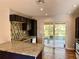 Bright kitchen features stainless steel appliances, granite counters, and backyard view at 9893 86Th N Way, Seminole, FL 33777