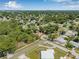 Aerial view of a neighborhood showcasing a home with mature trees and a well-maintained lawn at 9981 58Th N St, Pinellas Park, FL 33782