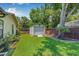 Grassy backyard featuring a storage shed and privacy fence at 9981 58Th N St, Pinellas Park, FL 33782