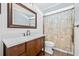 This cozy bathroom features a wood vanity, and a shower/bath with a decorative shower curtain at 9981 58Th N St, Pinellas Park, FL 33782