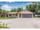 Inviting home with a two-car garage, stone accents, and a well-maintained front yard at 9981 58Th N St, Pinellas Park, FL 33782