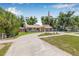 Charming home with a circular driveway and well-manicured lawn at 9981 58Th N St, Pinellas Park, FL 33782