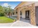 Stone-accented entryway with a covered porch, providing a welcoming entrance to the home at 9981 58Th N St, Pinellas Park, FL 33782