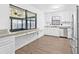 White kitchen boasts stainless steel appliances and a breakfast bar overlooking the backyard at 9981 58Th N St, Pinellas Park, FL 33782