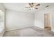 Bright bedroom with neutral carpet, ceiling fan and a view to the outside at 10150 Heather Sound Dr, Tampa, FL 33647