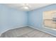 Serene bedroom featuring blue walls, neutral carpet, and a ceiling fan at 10150 Heather Sound Dr, Tampa, FL 33647