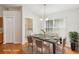 Bright dining room featuring stylish furniture, wood floors, and a view to the laundry room at 10150 Heather Sound Dr, Tampa, FL 33647