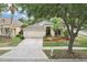 Inviting single-story home with lush landscaping, two-car garage, and a spacious driveway at 10150 Heather Sound Dr, Tampa, FL 33647