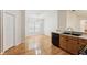 Kitchen with wooden cabinets and black appliances, adjacent to dining area with window at 10150 Heather Sound Dr, Tampa, FL 33647
